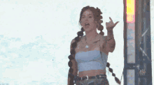 a woman is giving the middle finger while wearing a white top