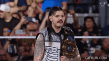 a man in a wrestling ring with a gifrun.com watermark on the bottom right