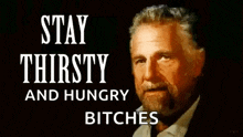 a man with a beard is standing in front of a sign that says `` stay thirsty and hungry bitches ''