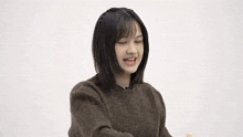 a young girl is making a funny face with her eyes closed .