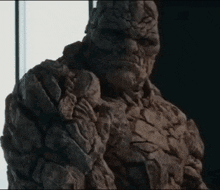 a close up of a statue of a rock monster