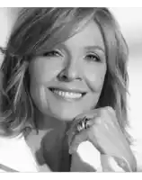 a woman with a ring on her finger is smiling in a black and white photo