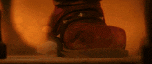 a close up of a red shoe with spikes on it