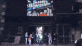 a group of anime girls are dancing on a dance floor in a room .