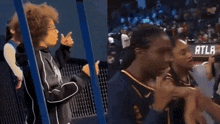 a woman in a basketball uniform with the number 1 on it talks to another woman