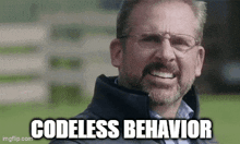 a man with glasses and a beard is smiling with the words `` codeless behavior '' written below him .