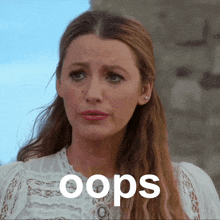 a woman wearing a white lace top with the word oops written on it