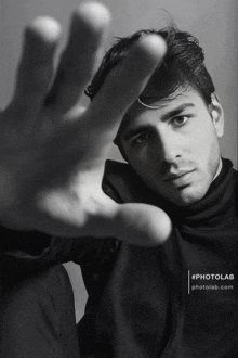 a black and white photo of a man 's face with the hashtag photolab.com