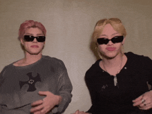 a man and a woman wearing sunglasses are making faces
