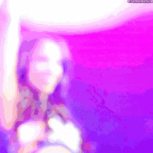 a blurry picture of a woman with a purple background and the words the next thing below her