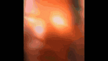 a close up of a red and orange background with a few white spots