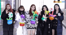 a group of girls are posing for a picture with balloons in their hands