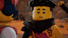 a lego figure with a scarf around his neck stands next to another figure