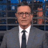 a man wearing glasses and a suit and tie