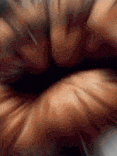 a close up of a person 's face with a blurred background