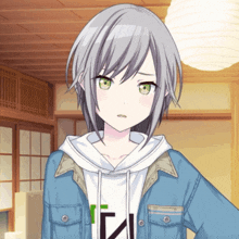 a girl with gray hair and green eyes is wearing a blue jacket and a white hoodie with the letter i on it