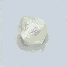 a large white diamond is sitting on a white surface .