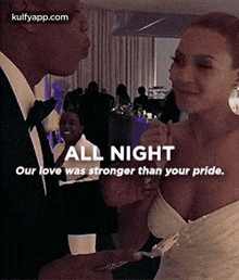 a man and a woman are standing next to each other at a party .