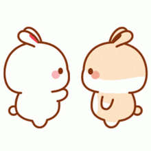 two cartoon rabbits are hugging each other and holding a heart .