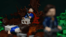 a group of lego figures are playing a game in a dark forest