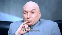 a bald man in a suit is holding his finger to his mouth and says doe ..