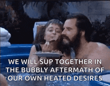a man and a woman are in a hot tub eating food