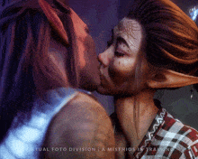 a painting of a man and woman kissing with the words virtual foto division a misthios in training below them