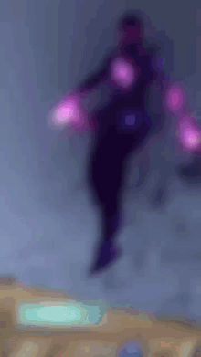 a blurry picture of a person 's shadow with purple lights behind them