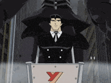 a man in a suit and tie is holding a shield with a red y on it
