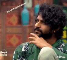 a man with curly hair and a beard is on a disney + hotstar show