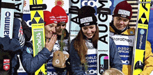 a group of skiers are posing for a picture with one wearing a hat that says bioteaqua