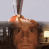 a close up of a man 's face with a knife pointing at it