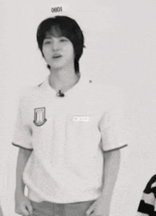 a black and white photo of a young man wearing a white shirt with the number 11 on it