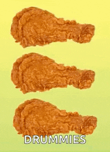 three drummies of fried chicken are lined up on a yellow and green background .