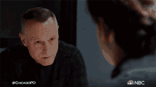 a man in a black shirt is talking to a woman with the hashtag #chicagopd
