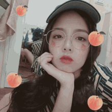 a girl wearing glasses and a hat with peach stickers on her face