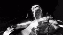 a black and white photo of a man dancing in a dark room