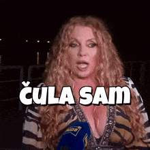 a woman in a striped shirt is talking into a microphone with the words " cula sam " written above her