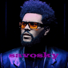 a man with a beard is wearing sunglasses and a blue jacket with the word savosky on it