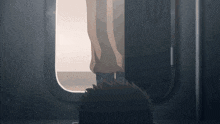 a person is standing in a doorway with their feet out