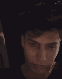 a close up of a young man 's face with his eyes closed and his mouth open .