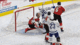 a hockey game is being played in front of a sign that says office technology