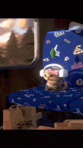 a dog wearing headphones is sitting on a blue chair with a bag that says ikea on it