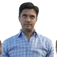a man wearing a plaid shirt is making a funny face