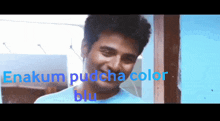 a man wearing a blue shirt with the words " enakum pudcha color blu " on the bottom