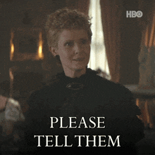 a woman in a black dress stands in front of a sign which says please tell them