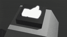a black box with a white thumbs up sign on top of it