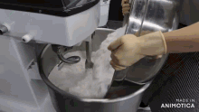 a person is mixing ingredients in a mixer with the words made in animotica visible in the corner