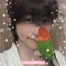 a person holding a green and orange parrot on their nose with the words sof y wonbin = < 3 below them