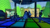 a group of people are dancing on a colorful dance floor in a room